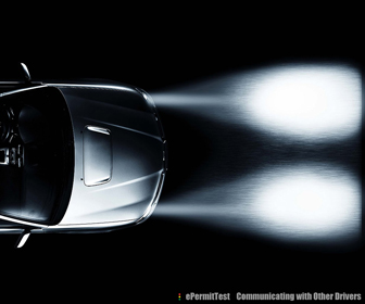 You can flash your headlights to know the other driver that his headlights are blinding you